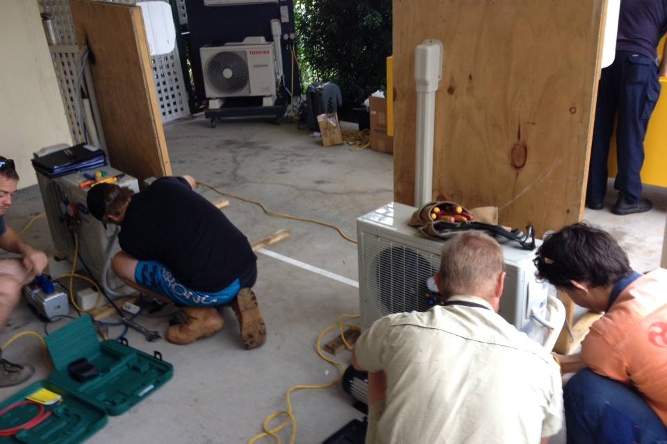 Students working on an air conditioner in our Melbourne split system course